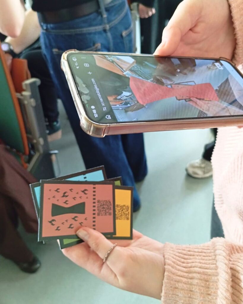 Phone scanning an Embracing Gaia game card during the AR Hunt in Kraków