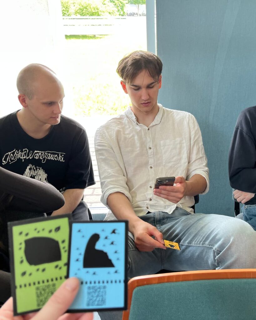 University students playing the Embracing Gaia AR Hunt using mobile devices in Kraków